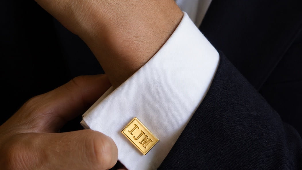 A client fastening a custom Laurenti cufflink before an appointment