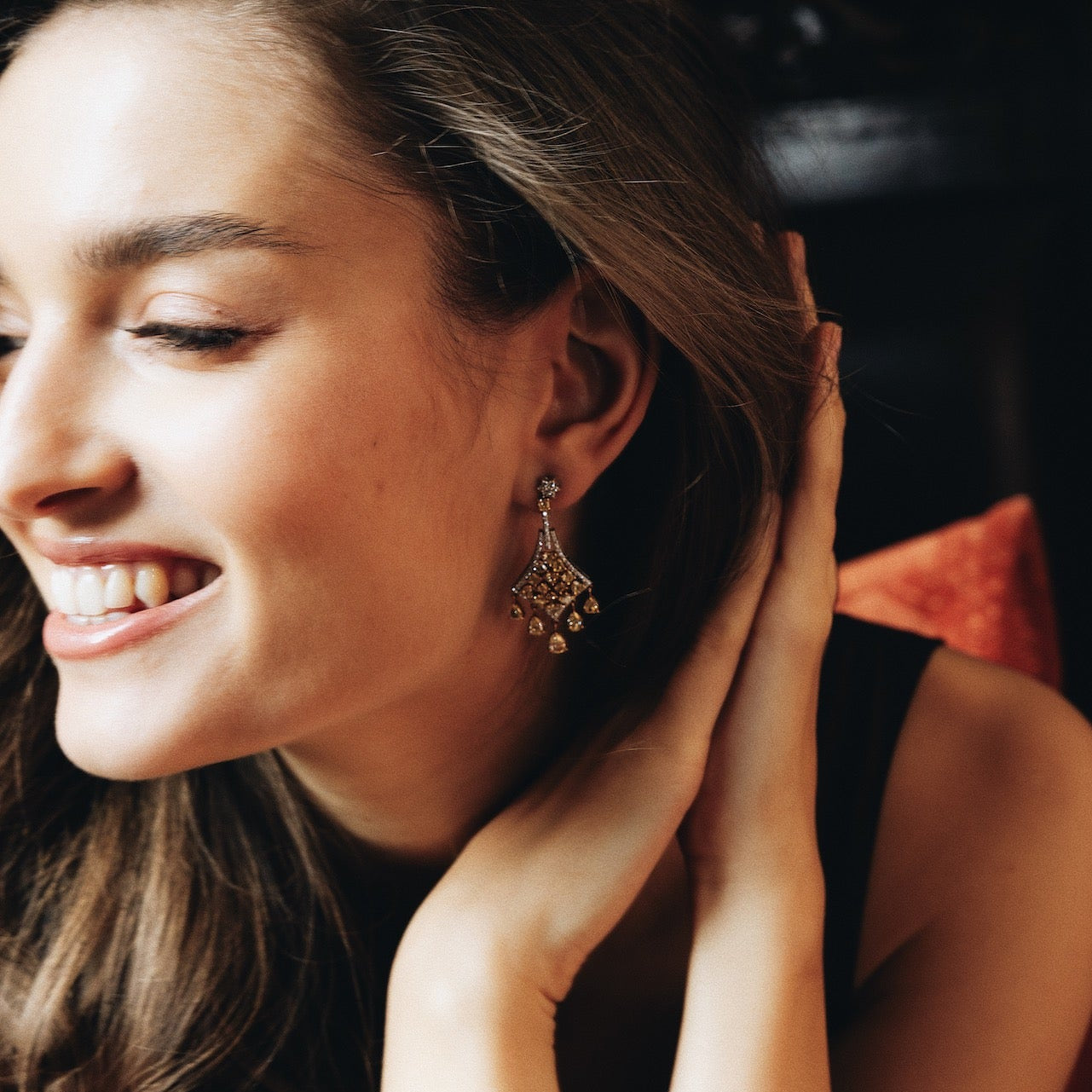 Model smiling while wearing Laurenti diamond earrings
